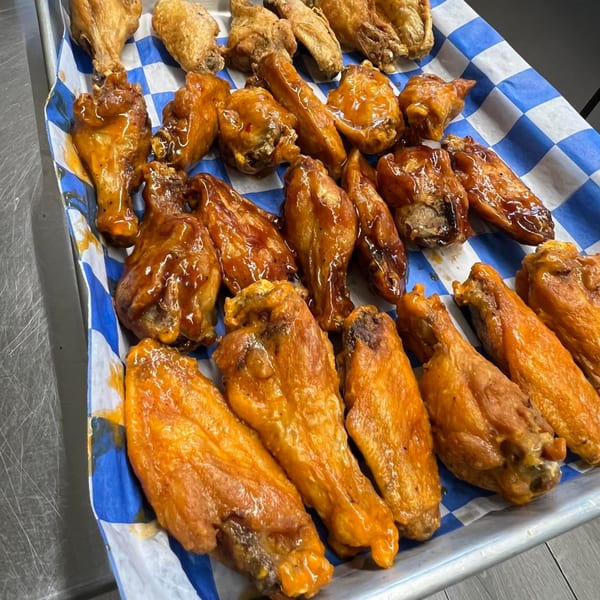 A tray of Pizzeria 131's chicken wings, some plain and some coated in barbecue sauce.