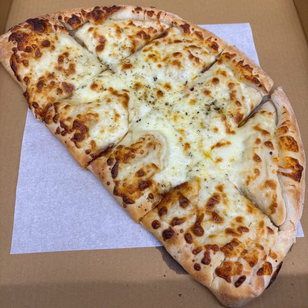 Pizzeria 131's cheesy garlic bread, cut into strips, in a brown pizza box.